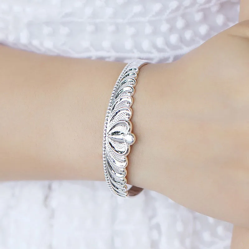 Silver electroplated crown bracelet for women on white background