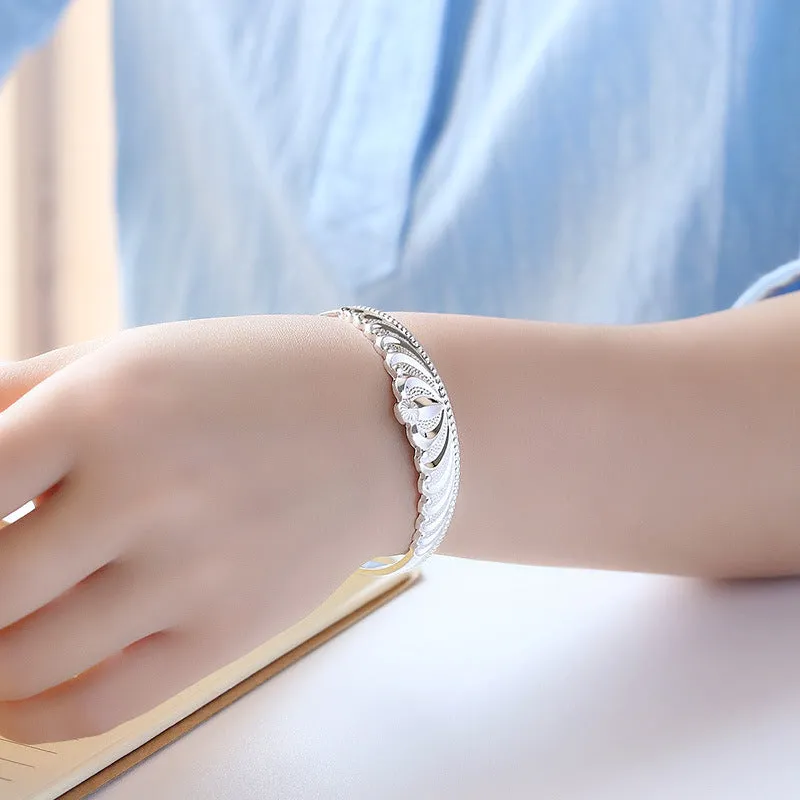 Silver electroplated crown bracelet for women on white background