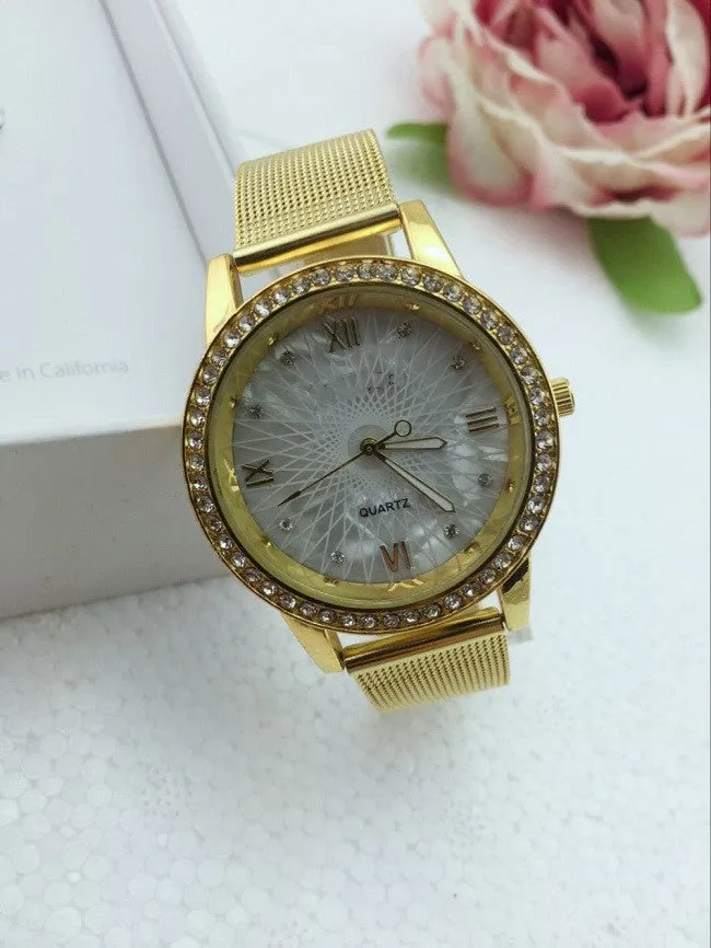 Golden mesh strap alloy electronic watch with round dial and world time GMT functions on a plain background