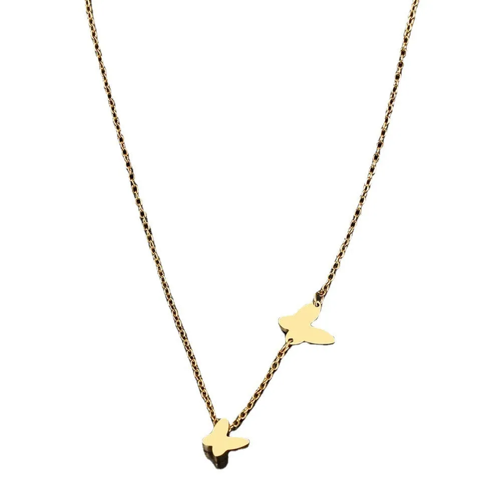 Butterfly pendant necklace in stainless steel with 18K gold electroplated finish on a white background
