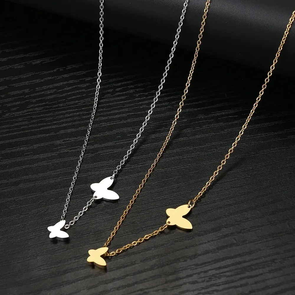 Butterfly pendant necklace in stainless steel with 18K gold electroplated finish on a white background