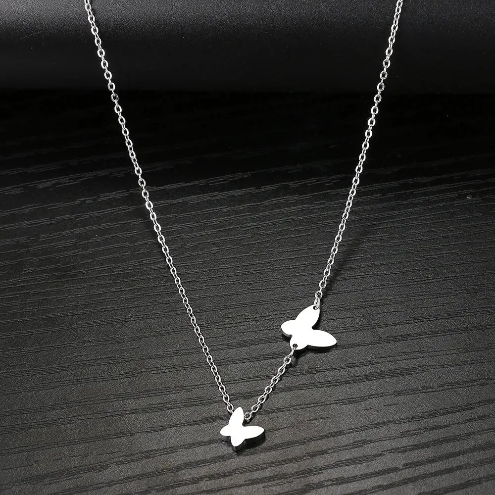 Butterfly pendant necklace in stainless steel with 18K gold electroplated finish on a white background
