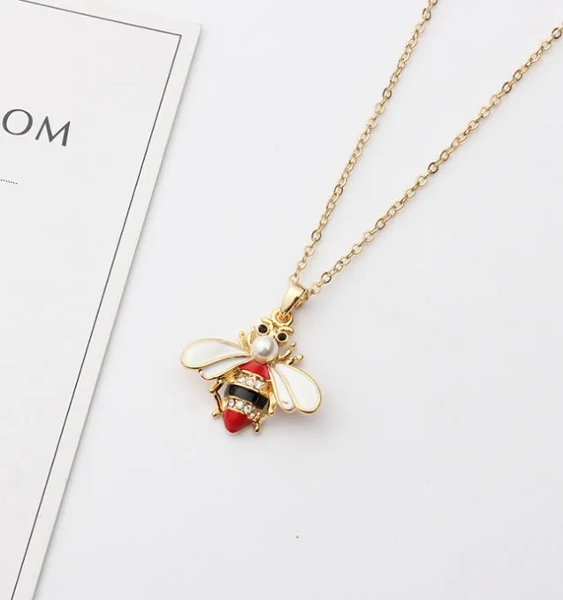 Cartoon bee drop pendant necklace with oil studded alloy finish on cross chain, yellow colour option, on white background