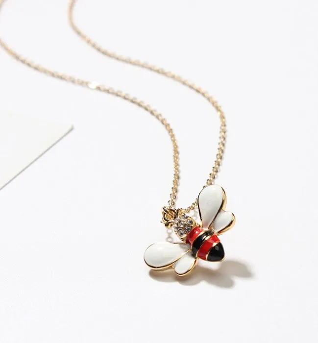 Cartoon bee drop pendant necklace with oil studded alloy finish on cross chain, yellow colour option, on white background