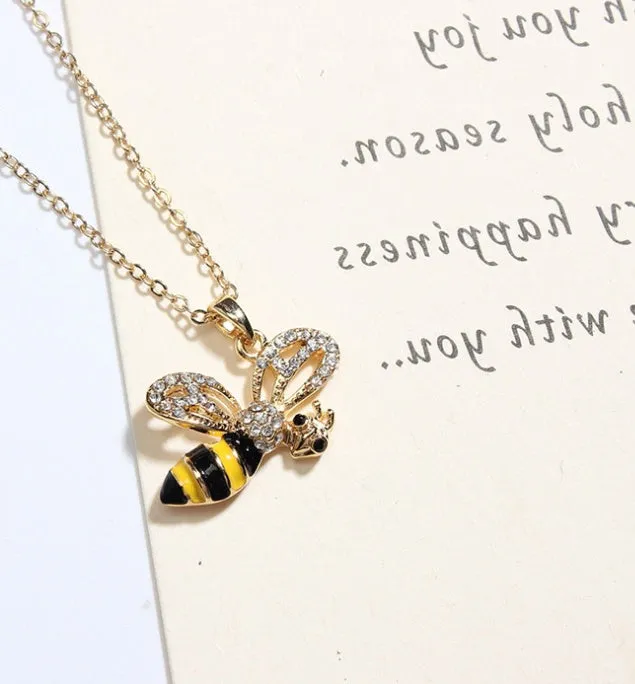 Cartoon bee drop pendant necklace with oil studded alloy finish on cross chain, yellow colour option, on white background