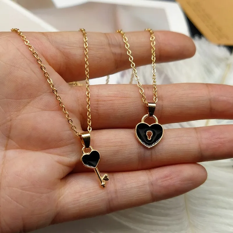 Small alloy lock and key pendant necklace set in black with 40cm chain on white background