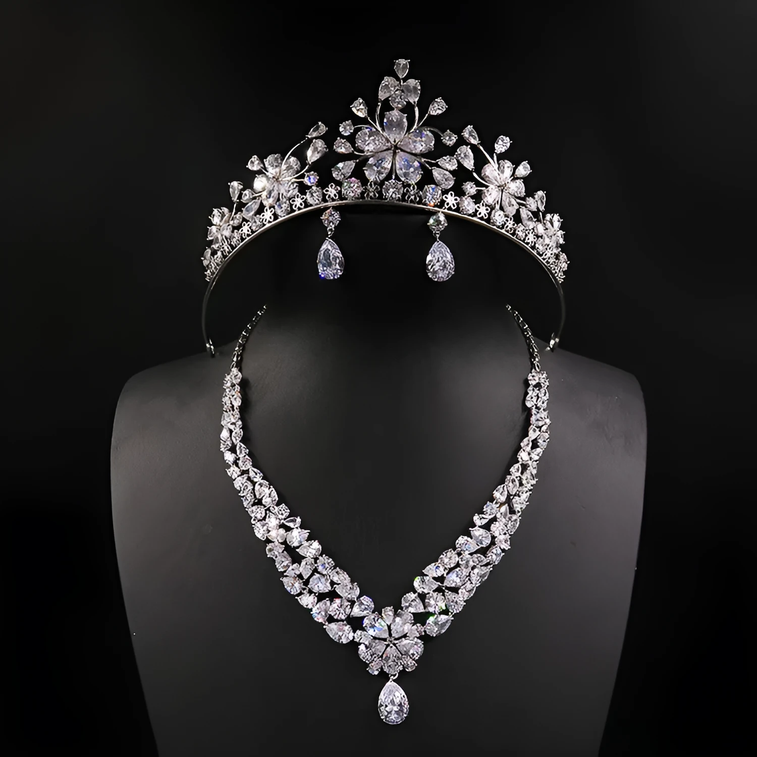 Three piece bridal jewellery set with gold leaf crown necklace and earrings on white background