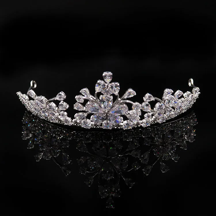 Three piece bridal jewellery set with gold leaf crown necklace and earrings on white background