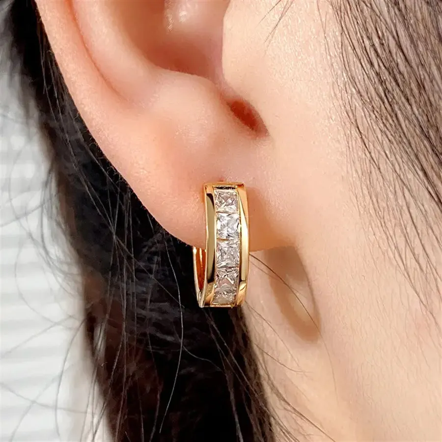 A pair of geometric quadrilateral earrings for women in a gold tone, showing the post and butterfly clutch back.