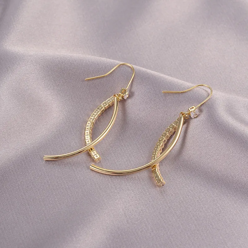 Pair of gold irregular geometric copper earrings on display