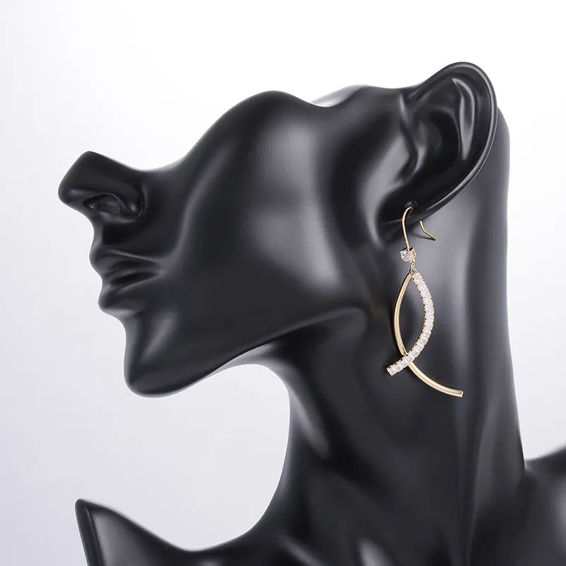 Pair of gold irregular geometric copper earrings on display