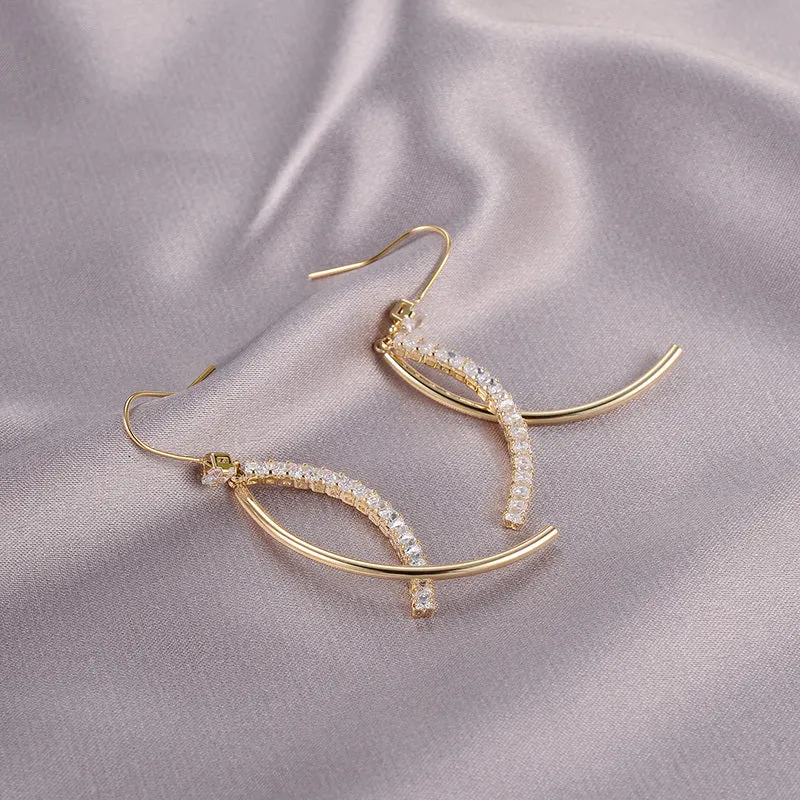 Pair of gold irregular geometric copper earrings on display