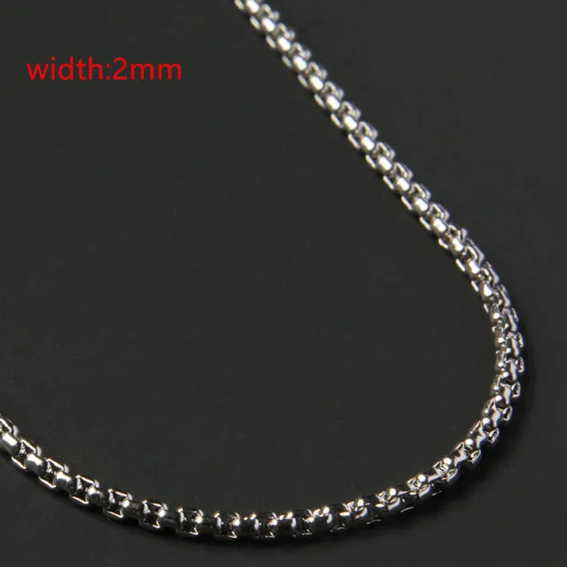 Less steel Figaro Cuban chain necklace in silver on white background showing links and clasp