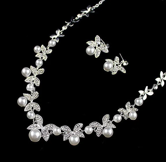 Bridal jewellery set with leaf design necklace and earrings featuring simulated pearls and cubic zirconia in silver white