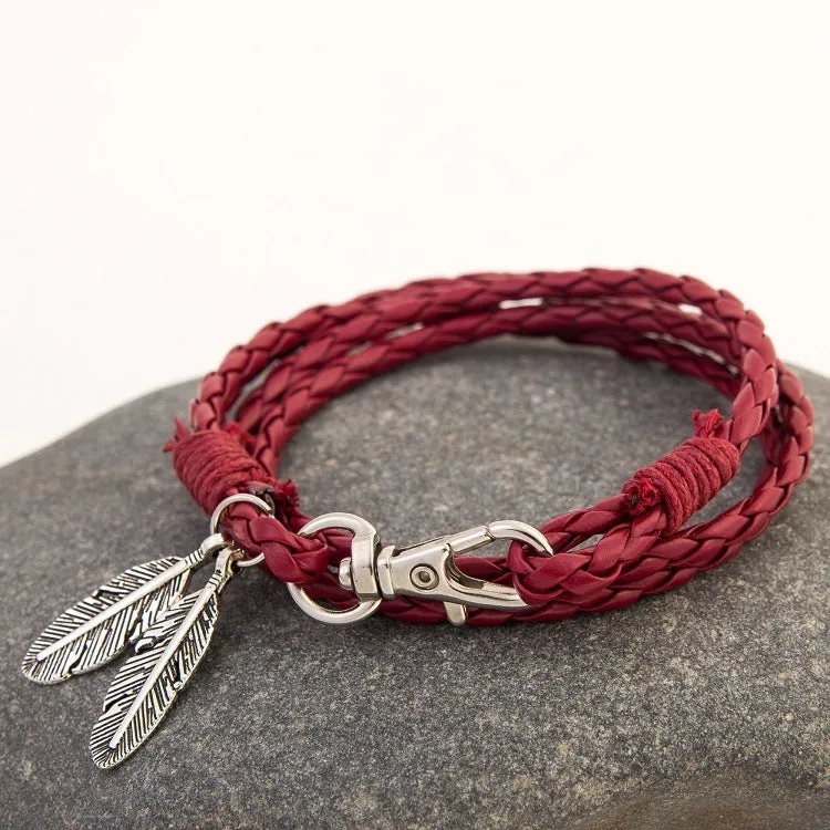 Leather charm friendship bracelet with buckle closure in black brown on white background