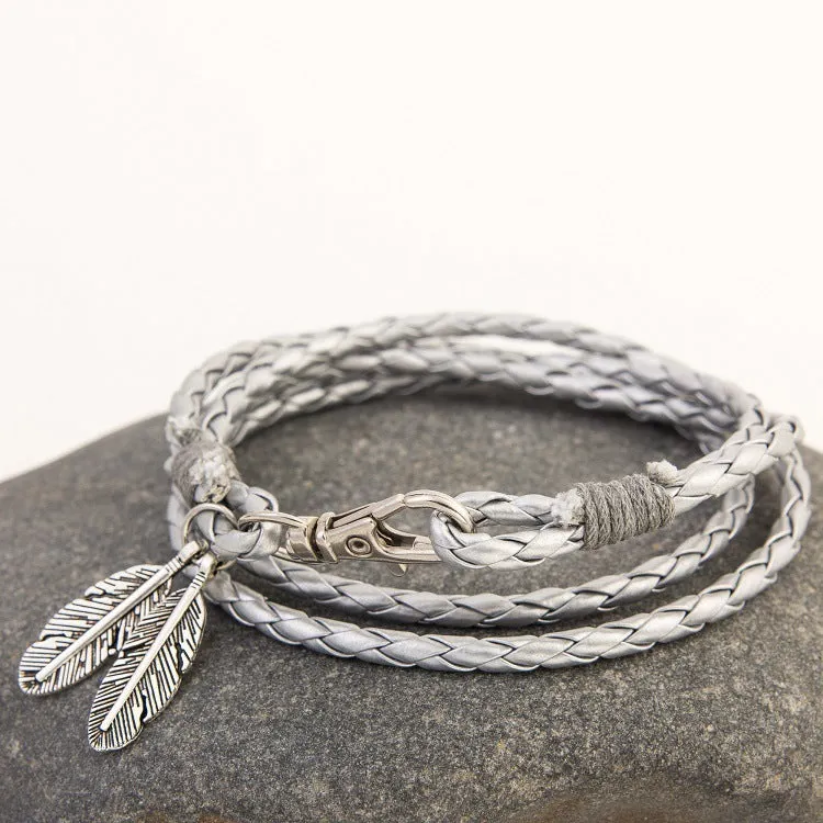 Leather charm friendship bracelet with buckle closure in black brown on white background