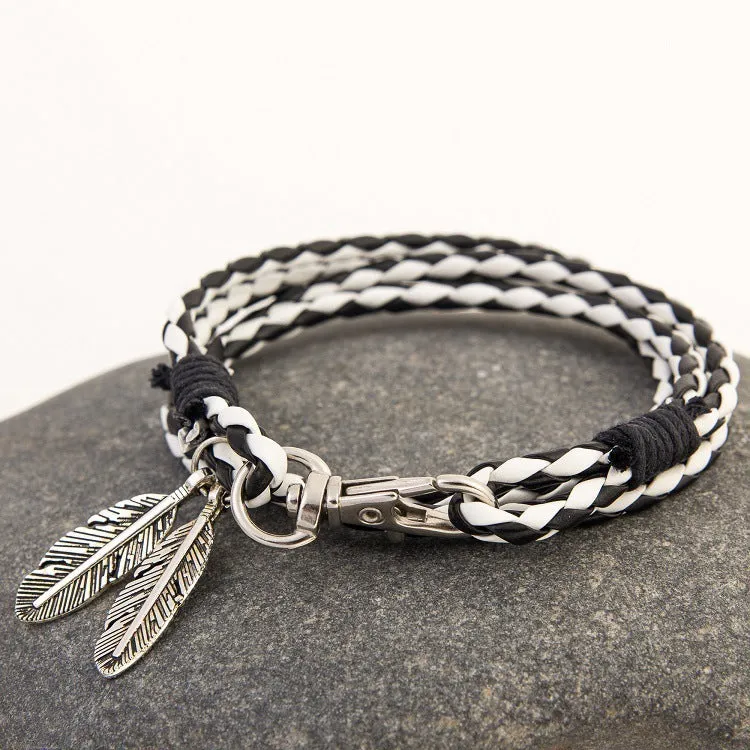Leather charm friendship bracelet with buckle closure in black brown on white background