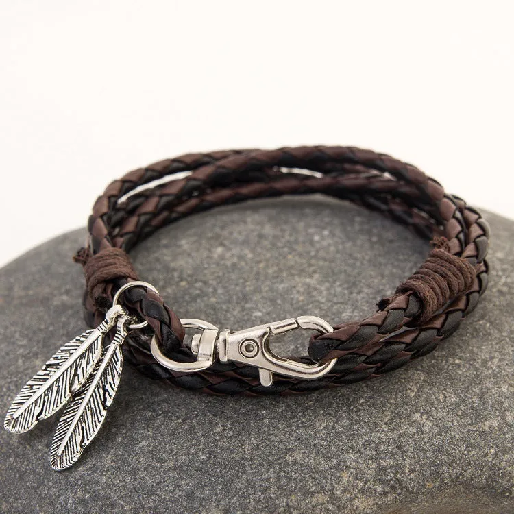 Leather charm friendship bracelet with buckle closure in black brown on white background