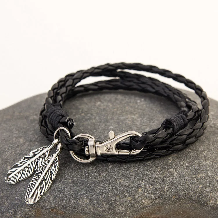 Leather charm friendship bracelet with buckle closure in black brown on white background