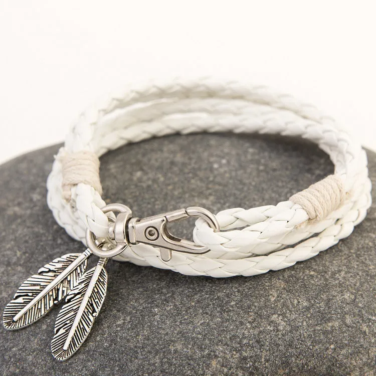 Leather charm friendship bracelet with buckle closure in black brown on white background