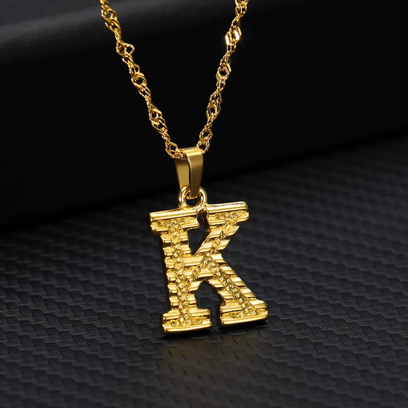 Gold-plated alloy initial pendant necklace with 42cm chain on white background