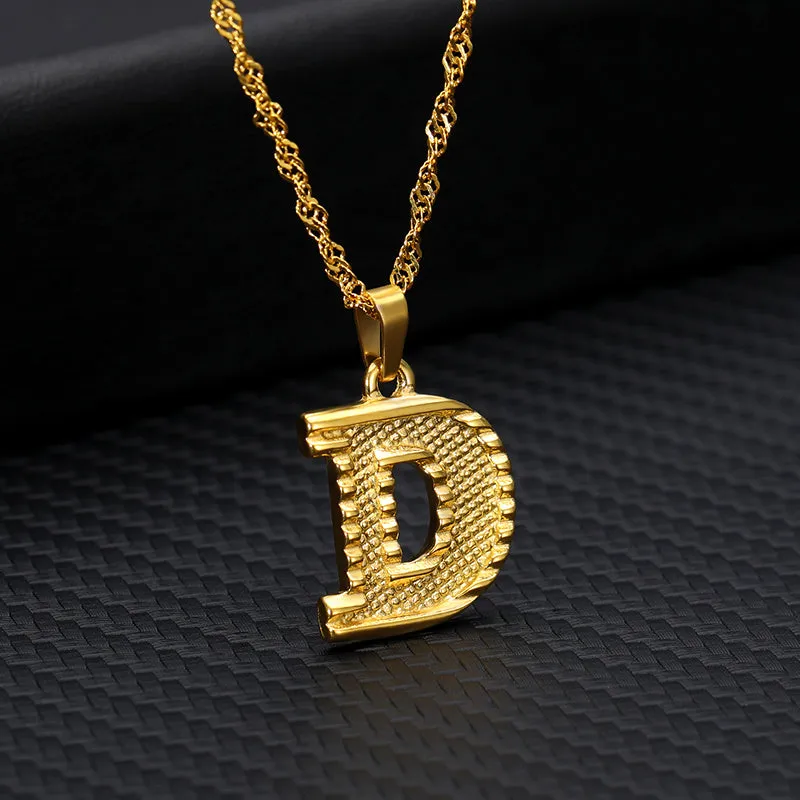 Gold-plated alloy initial pendant necklace with 42cm chain on white background
