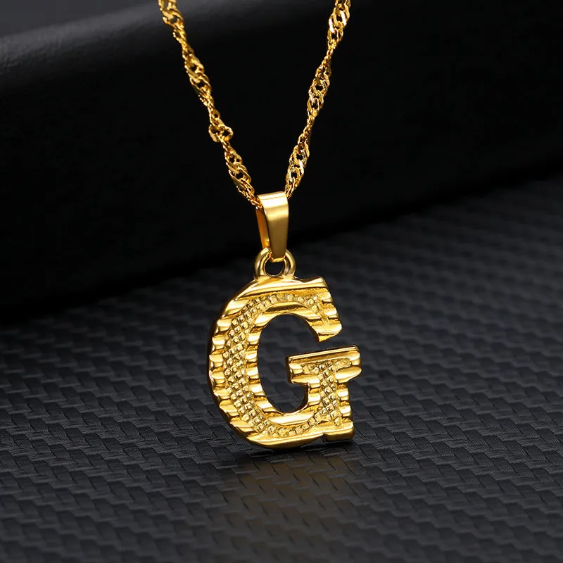 Gold-plated alloy initial pendant necklace with 42cm chain on white background