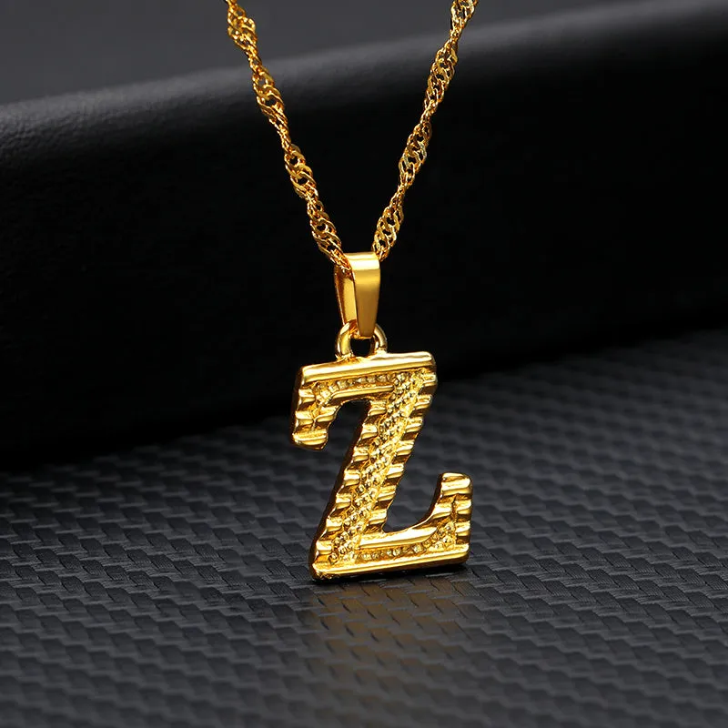 Gold-plated alloy initial pendant necklace with 42cm chain on white background