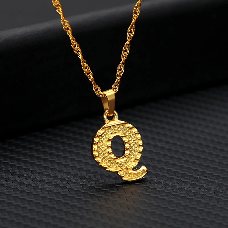 Gold-plated alloy initial pendant necklace with 42cm chain on white background