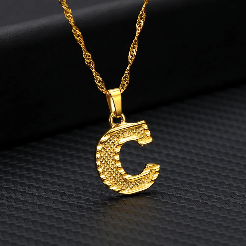 Gold-plated alloy initial pendant necklace with 42cm chain on white background
