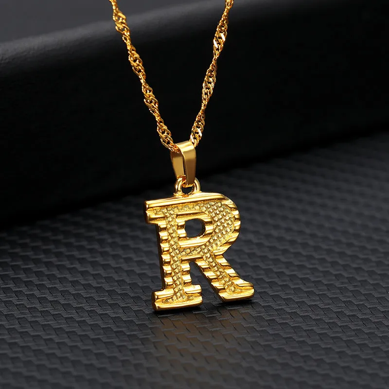 Gold-plated alloy initial pendant necklace with 42cm chain on white background