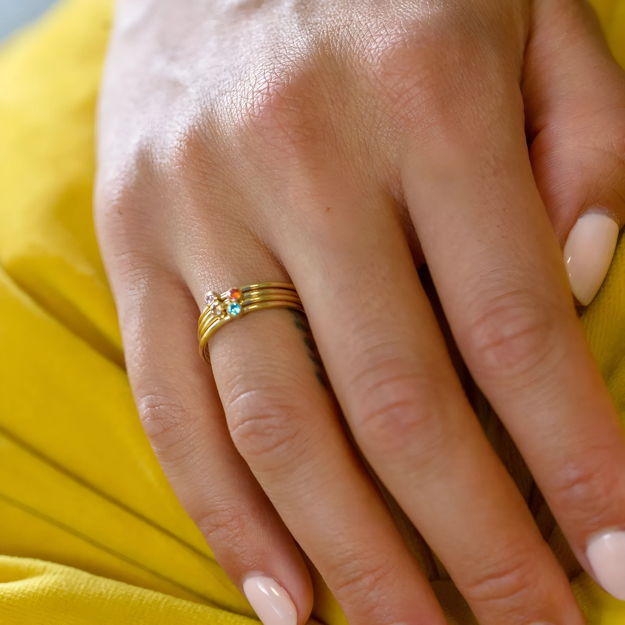 December colour birthstone ring with geometric engraving on a gold electroplated titanium steel band.