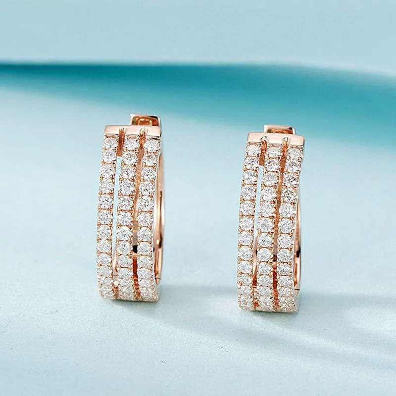 18K white gold natural diamond earrings with 56 point diamond in platinum finish on light background