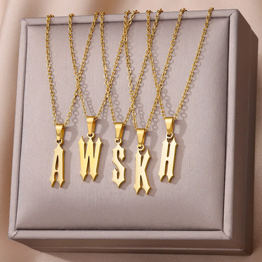 Gold stainless steel ancient English letter pendant necklace with O-ring chain on white background