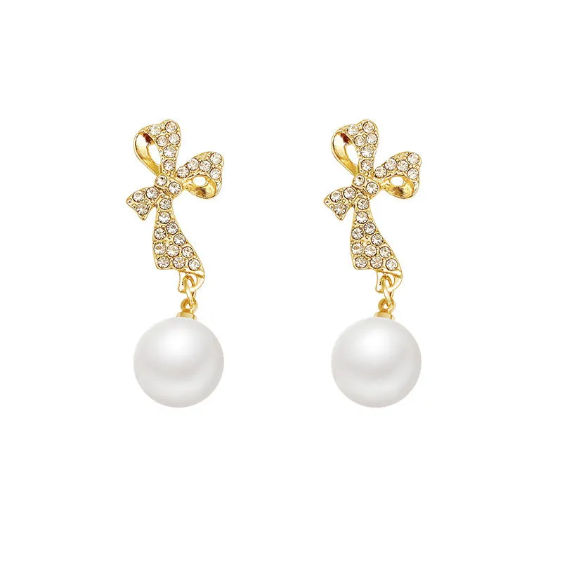 Gold butterfly earrings with rhinestones and bow element on alloy base