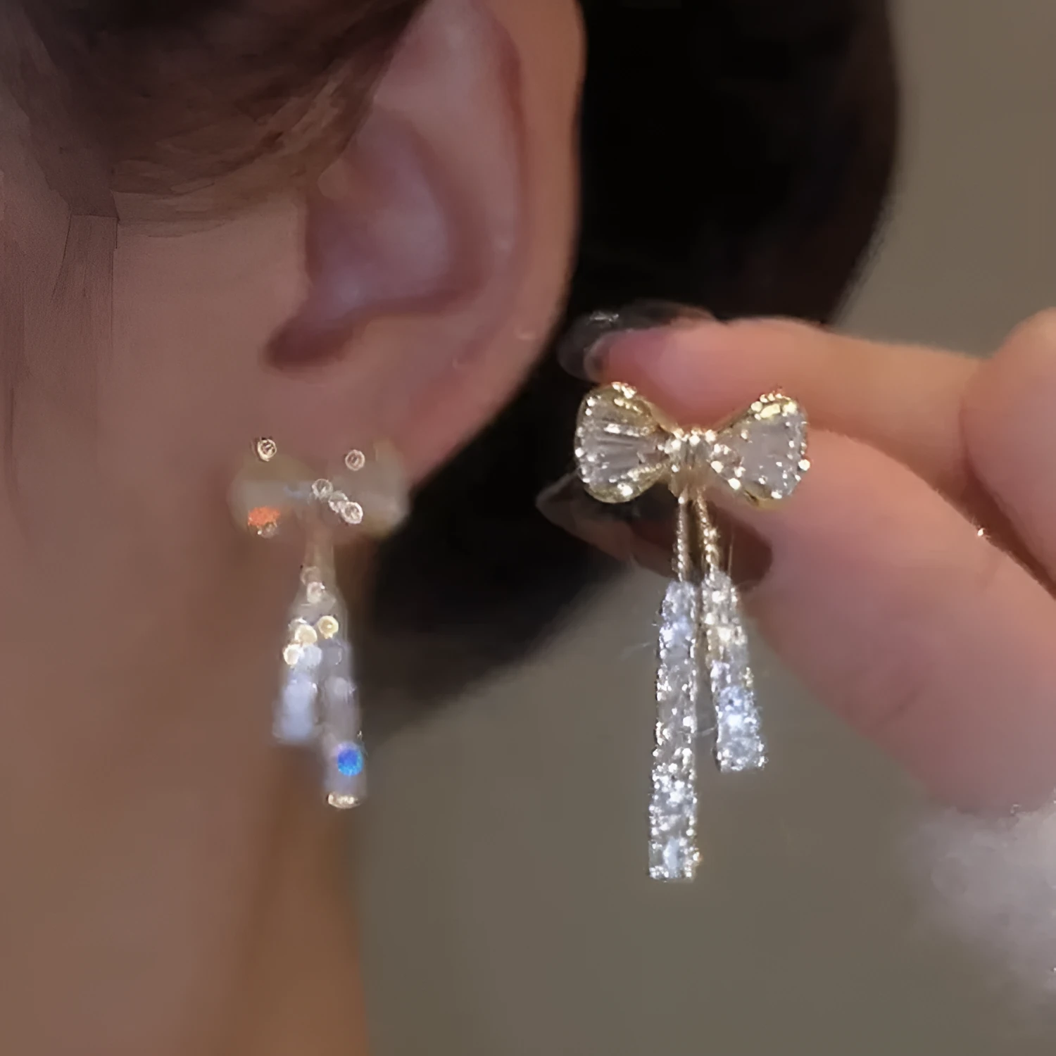 Gold butterfly earrings with rhinestones and bow element on alloy base