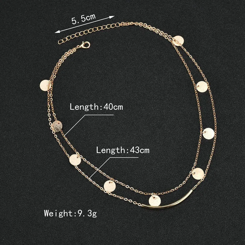 Gold alloy geometric pendant necklace with multi-sequin finish on display