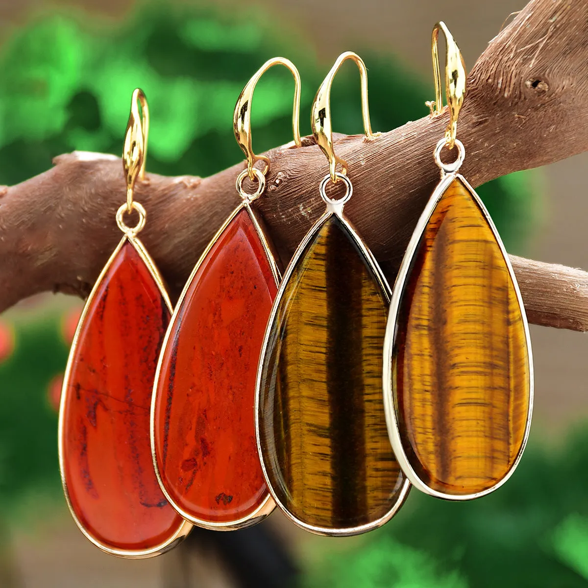 Vintage long water drop earrings in tigereye stone with textured surface and dangle silhouette