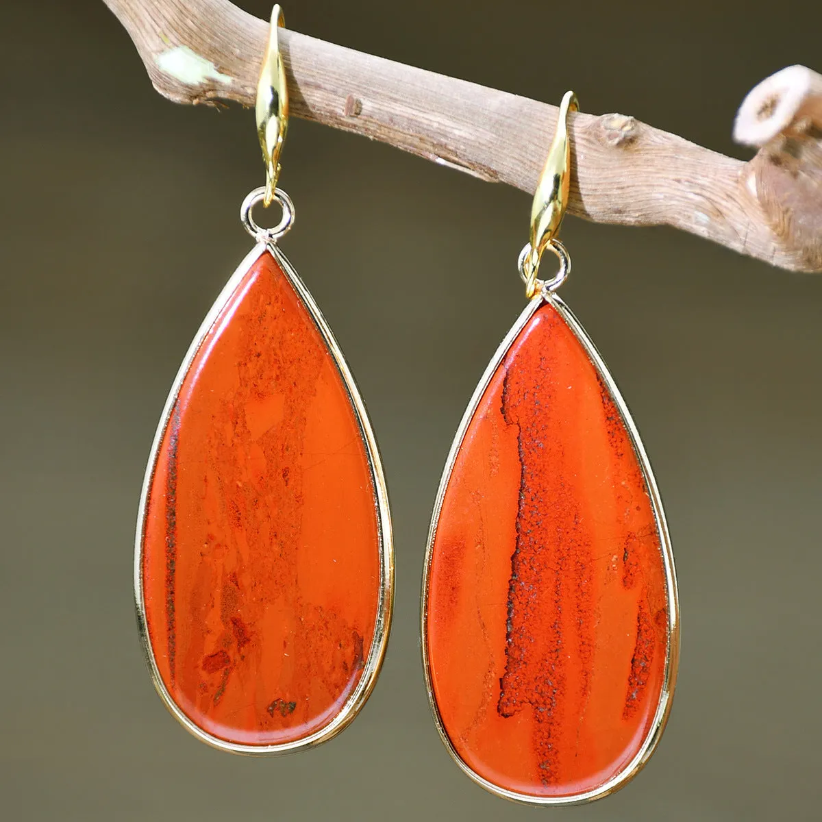 Vintage long water drop earrings in tigereye stone with textured surface and dangle silhouette