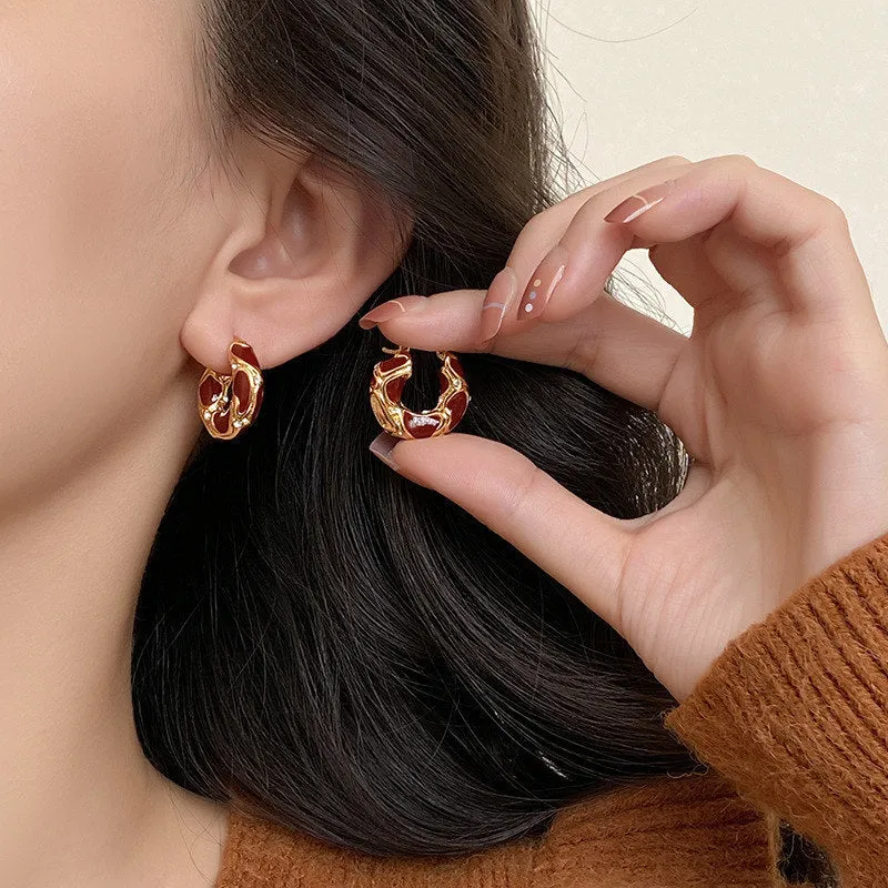 Gold plated alloy small hoop earrings with enamel colour in red, black, and white geometric shapes
