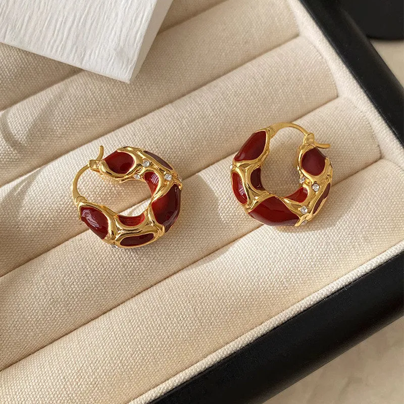 Gold plated alloy small hoop earrings with enamel colour in red, black, and white geometric shapes