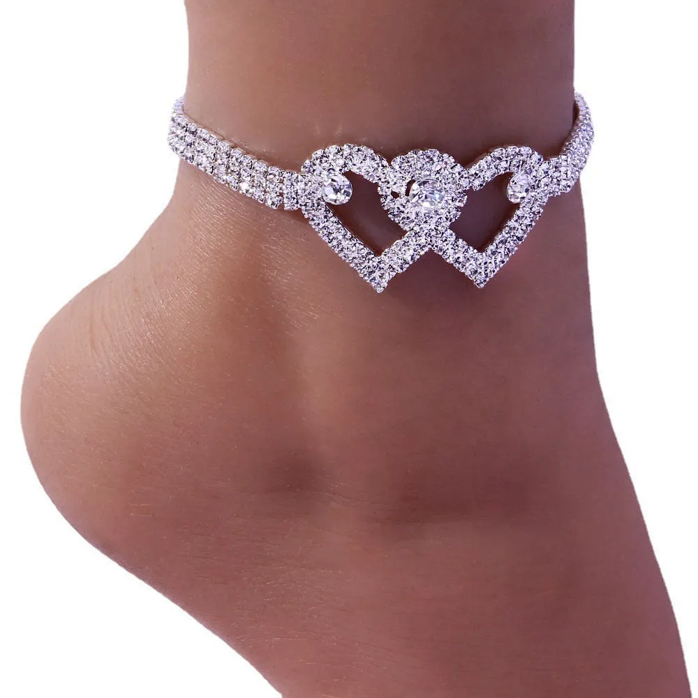 Set of two alloy double heart anklets with electroplated finish, unisex style, displayed together