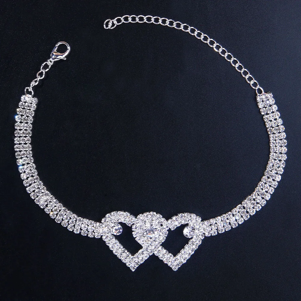 Set of two alloy double heart anklets with electroplated finish, unisex style, displayed together
