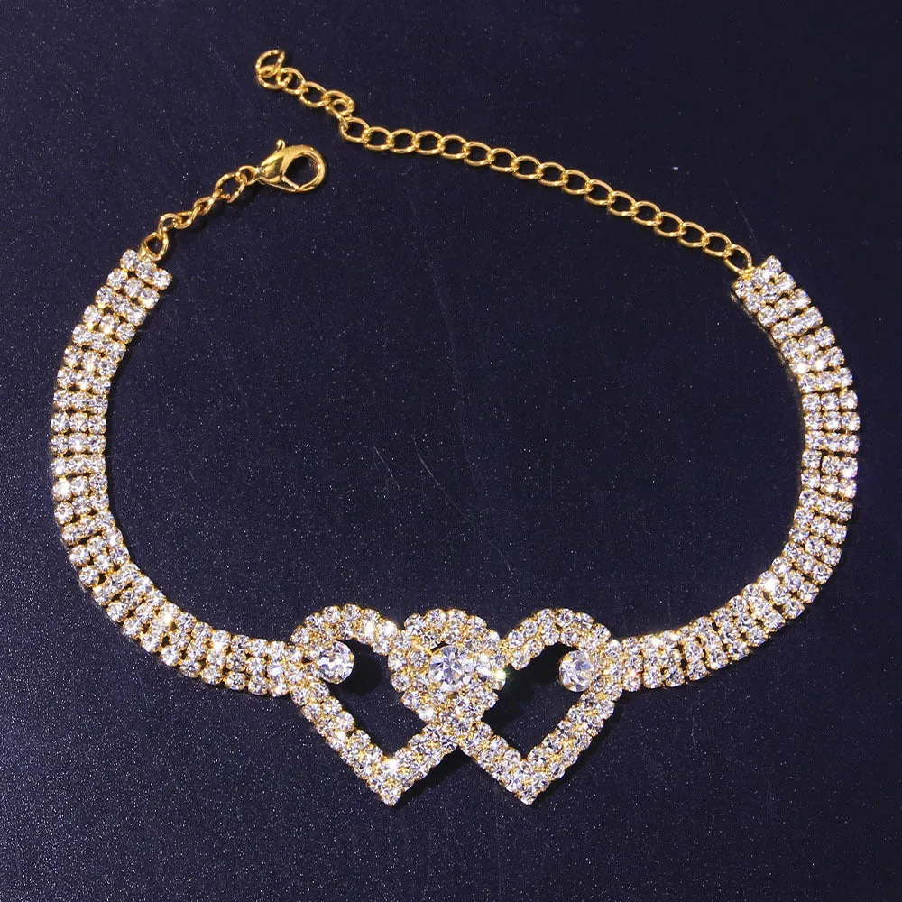 Set of two alloy double heart anklets with electroplated finish, unisex style, displayed together
