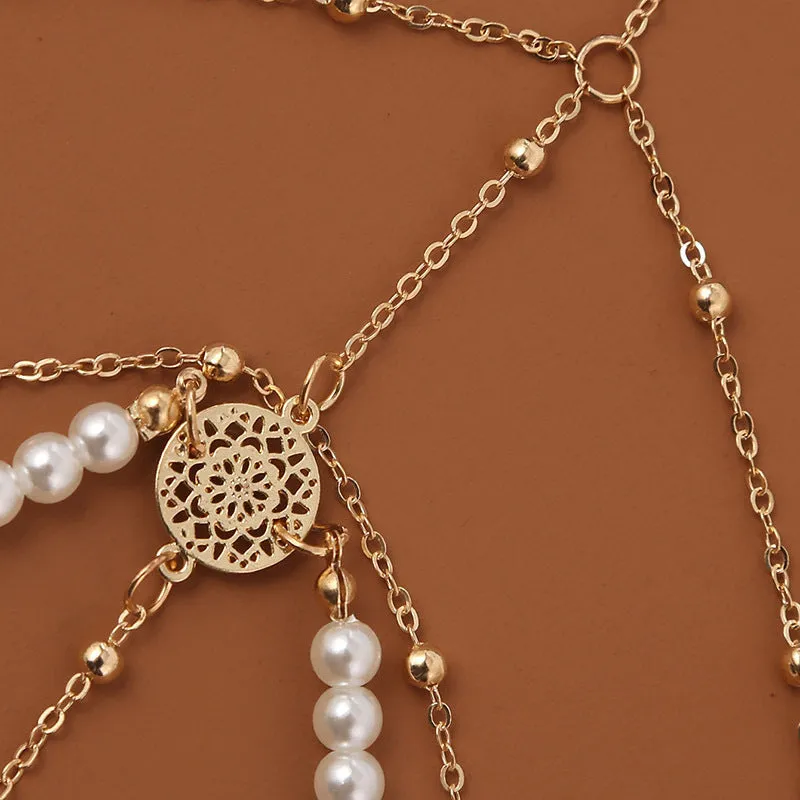 Women's white pearl multi-layer geometric body chain anklet on a light background