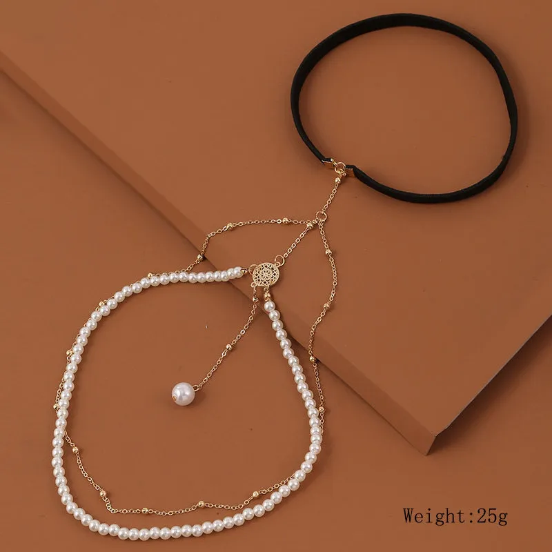 Women's white pearl multi-layer geometric body chain anklet on a light background