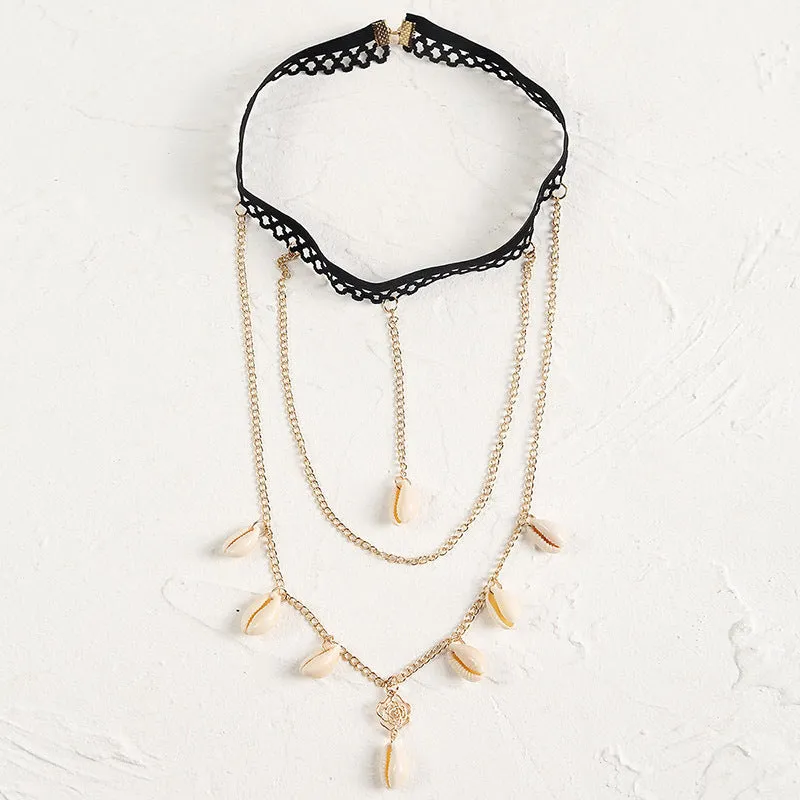 Women's white pearl multi-layer geometric body chain anklet on a light background
