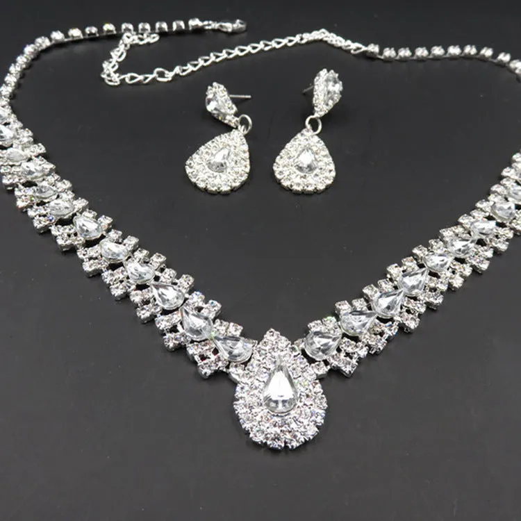 Gold bride wedding accessories set with drop earrings and necklace on white background