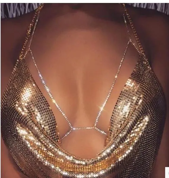 Women's rhinestone metal body chain necklace in gold on a model showing torso wear