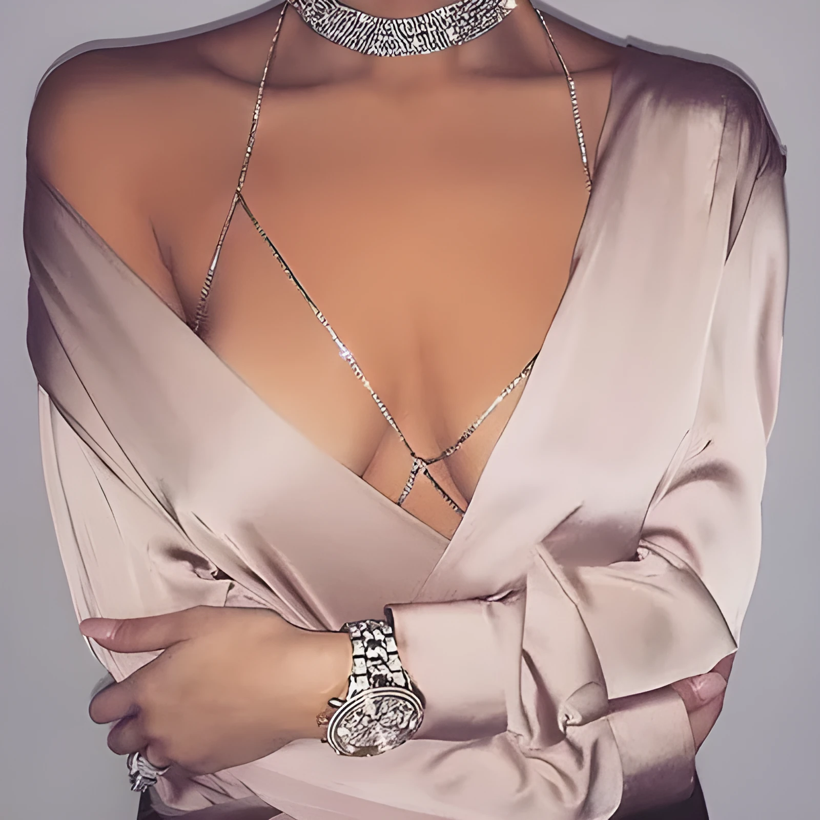 Women's rhinestone metal body chain necklace in gold on a model showing torso wear